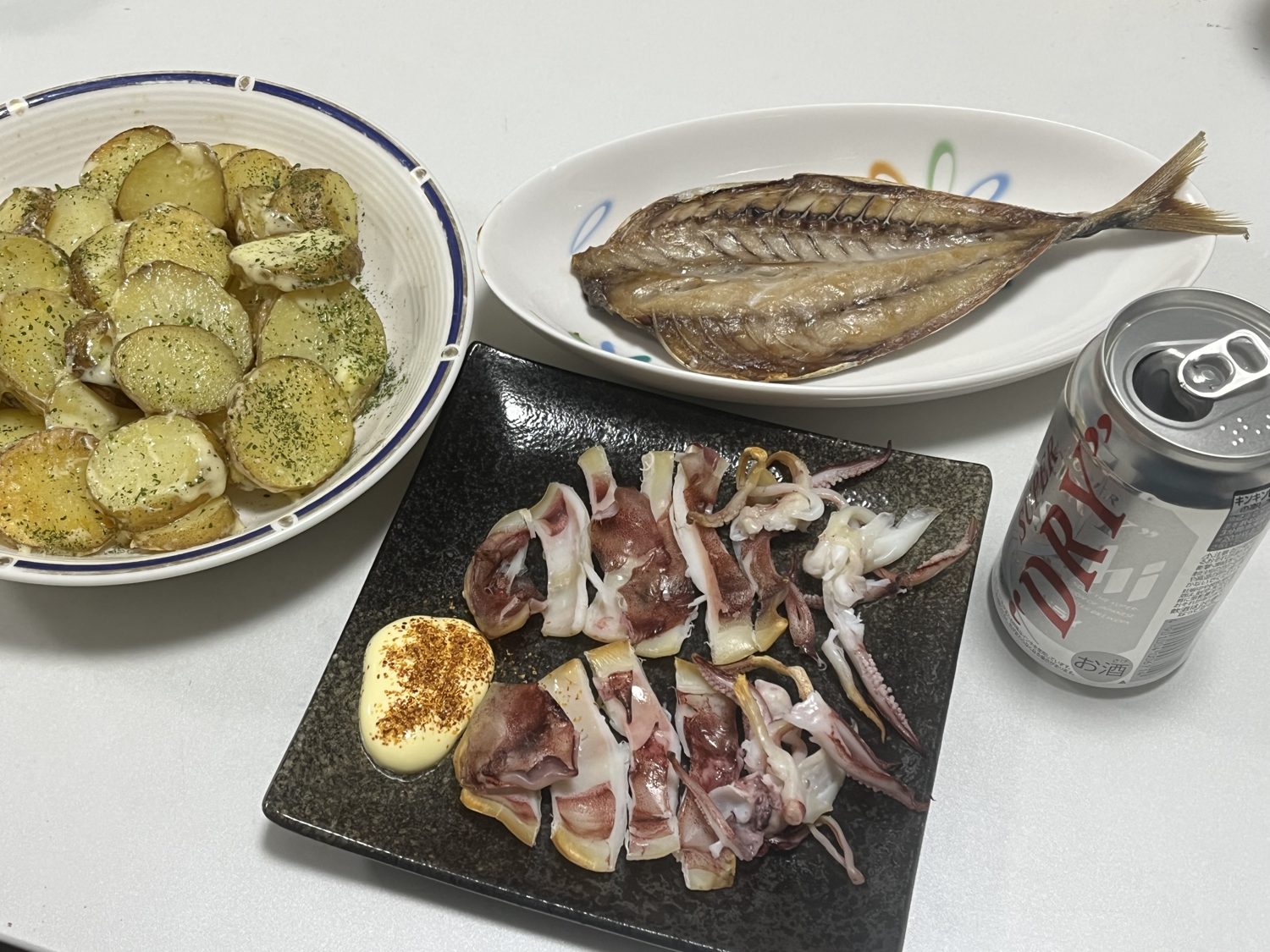 焼いたイカの干物、ムロアジの干物、じゃがバターチーズ、缶ビールの晩ご飯